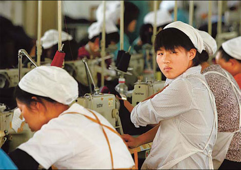 Workers at an apparel factory in Huaibei, Anhui province. China's trade surplus could be trimmed as the nation is planning stimulus measures to boost imports.[China Daily]
