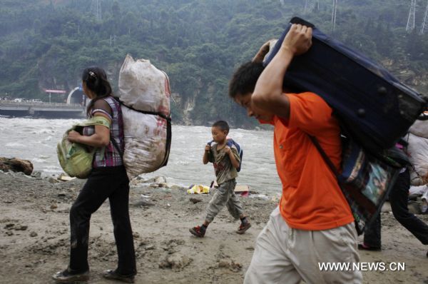 People trapped at upstream area of a barrier lake evacuate to safe place in Yongxiu Town, Wenchuan County, southwest China's Sichuan Province, Aug. 17, 2010. Heavy rain triggered landslides in several towns of Wenchuan County Aug. 14, where an 8-magnitude earthquake claimed almost 70,000 lives on May 12, 2008.