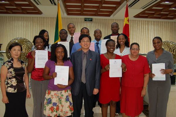 11 Jamaican students holding their Admission Notice Letters  take a photo with staff of Chinese Embassy in Jamaica, August 17, 2010.