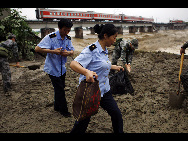 Two carriages of a passenger train fell into a river after floods destroyed a bridge in Guanghan, Sichuan province, August 19, 2010. All the passengers were evacuated and no casualties have been reported so far.[Xinhua]