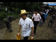 Two carriages of a passenger train fell into a river after floods destroyed a bridge in Guanghan, Sichuan province, August 19, 2010. All the passengers were evacuated and no casualties have been reported so far.[Xinhua]