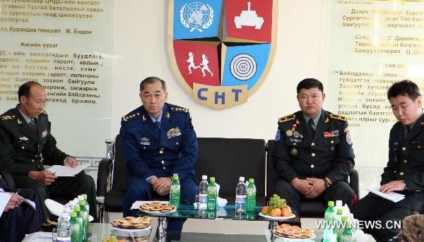 Ma Xiaotian (2nd L), deputy chief of the General Staff of the Chinese People's Liberation Army, listens to the introduction of the peacekeeping training center of Mongolia, in Ulan Bator, capital of Mongolia, Aug. 19, 2010. Ma Xiaotian arrived in Ulan Bator on Thursday.[A Sigang/Xinhua]