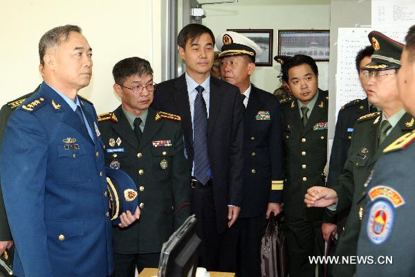 Ma Xiaotian (L), deputy chief of the General Staff of the Chinese People's Liberation Army, listens to the introduction of Khaan Quest 2010, a training exercise hosted in the peacekeeping training center of Mongolia, in Ulan Bator, capital of Mongolia, Aug. 19, 2010. Ma Xiaotian arrived in Ulan Bator on Thursday. [A Sigang/Xinhua]