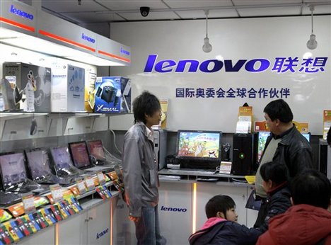 Customers make inquiries at a Lenovo store inside a computer market. 