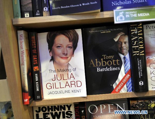 Books about Julia Gillard and Tony Abbott are pictured in a bookstore at the airport in Sydney, Australia, Aug. 21, 2010. Polls opened Saturday morning for Australia's federal elections for the 43rd Parliament amidst a poll-suggestion that Prime Minister Julia Gillard led Labor Party is running neck-and-neck with Tony Abbott led Coalition. [Huang Xiaoyong/Xinhua]