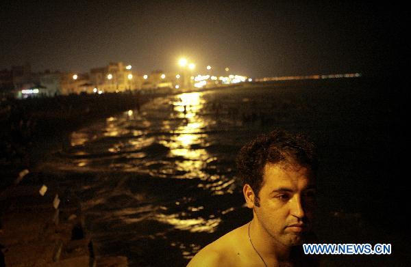  An Iranian man stands after swimming at seaside near the Bushehr nuclear power plant in southern Iran, Aug. 20, 2010. Nuclear fuel is going be loaded to Bushehr nuclear power plant the first one in Iran on Aug. 21. Bushehr nuclear power plant draws great attention after the U.S. Chairman of the Joint Chiefs of Staff Mike Mullen said earlier this month that the United States has a plan in place to attack Iran, if it is necessary.[Ahmad Halabisaz/Xinhua] 