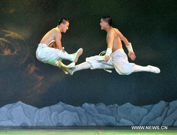 Monks from the Shaolin Temple perform Shaolin Martial Arts Show at the Entertainment Hall of the World Expo Park, in Shanghai, east China, Aug. 19, 2010. Two distinctive martial arts performances were respectively staged by monks from the Shaolin Temple and members of the kungfu team under the Wudang Taoist Association in the World Expo Park in recent days. [Ding Haitao]Xinhua]
