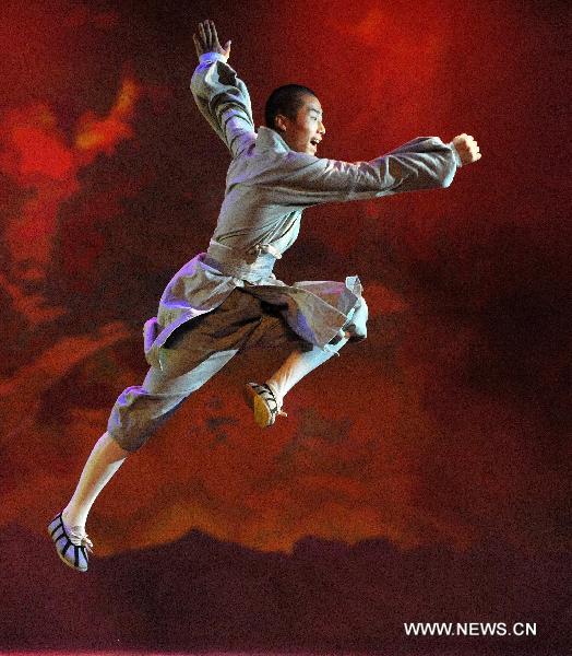 A monk from the Shaolin Temple performs Shaolin Martial Arts Show at the Entertainment Hall of the World Expo Park, in Shanghai, east China, Aug. 19, 2010. Two distinctive martial arts performances were respectively staged by monks from the Shaolin Temple and members of the kungfu team under the Wudang Taoist Association in the World Expo Park in recent days. [Ding Haitao/Xinhua]