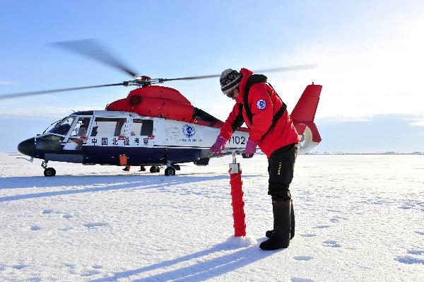 He Jianfeng, a member of the fourth Chinese scientific expedition team, collects the ice core sample at the North Pole, Aug. 20, 2010. The Chinese fourth expedition team arrived at the North Pole on 15:38 p.m. (0738 GMT) Friday, which is the northernmost location ever reached by Chinese scientific expeditions.[Zhang Jiansong/Xinhua]