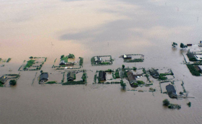 Four people are dead, one is missing and more than 64,000 others were forced to evacuate their homes Saturday after the swollen Yalu River, which marks the border with the Democratic People&apos;s Republic of Korea (DPRK), flooded Dandong City in northeast China&apos;s Liaoning Province.