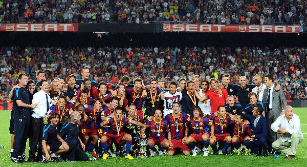 FC Barcelona's player celebrate a victory with the trophy against Sevilla during their Supercup final second leg soccer match at the Camp Nou Stadium in Barcelona in Barcelona, Spain, Aug. 21, 2010. Lionel Messi scored a hat trick as Barcelona won a record ninth Supercup by beating Sevilla 4-0 in the second leg for a 5-3 aggregate on Saturday.