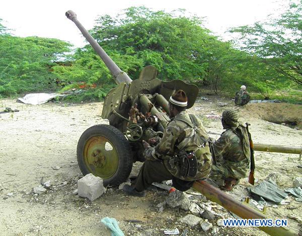 Members of the Islamist Al Shabaab movement prepare an artillery machine at their base in Mogadishu, Somalia, Aug. 23, 2010. Al Shabaab declared an all-out war against African Union peacekeeping forces and Somali government troops in Mogadishu on Monday. At least 40 civilians were killed and 106 others wounded in the lastest fierce clashes in Mogadishu. [Ismail Warsameh/Xinhua]
