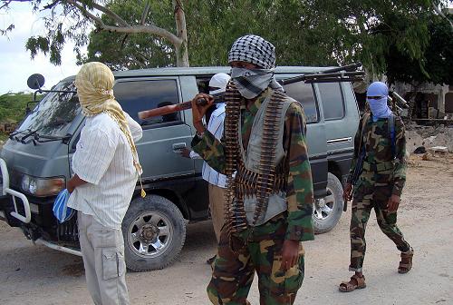 Somalia's Islamist Shebab fighters patrol on August 23, 2010 near a camp in northern Mogadishu Suqaholaha neighborhood minutes before they engaged in an offensive against the Somali government forces.[Xinhua] 