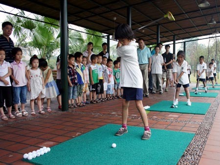 Captions: Students practicing golf.