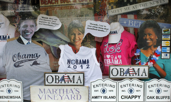 Cutouts of U.S. President Barack Obama (L), former Alaska Governor Sarah Palin (C) and First Lady Michelle Obama wear T-shirts in a shop window display in Edgartown, Massachusetts August 23, 2010. The first family is spending their summer vacation on the island of Martha&apos;s Vineyard.[Xinhua/Reuters] 