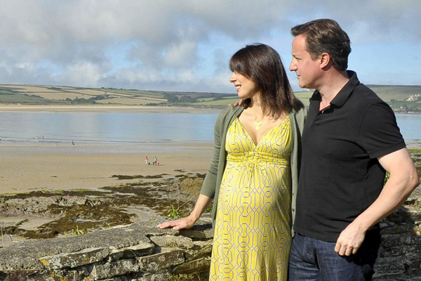 Britain&apos;s Prime Minister David Cameron, and his wife Samantha, pose for a photograph on the coastal path at Daymer Bay in Cornwall, August 22, 2010, just two days before Samantha Cameron gave birth to the couple&apos;s fourth child, a baby girl. [Xinhua/Reuters]