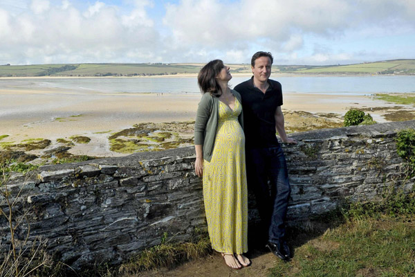 Britain&apos;s Prime Minister David Cameron, and his wife Samantha, pose for a photograph on the coastal path at Daymer Bay in Cornwall, August 22, 2010, just two days before Samantha Cameron gave birth to the couple&apos;s fourth child, a baby girl. [Xinhua/Reuters] 