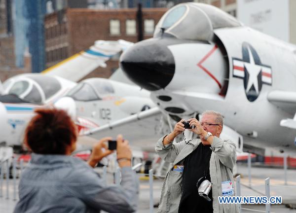 Tourists take photos at the Intrepid Sea, Air and Space Museum in New York, the United States, Aug. 24, 2010. The Air Force Week NYC held its opening ceremony at the museum on Tuesday. [Xinhua]