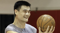 Houston rockets center Yao Ming, of china, smiles as the holds out a basketball for a teammate during a workout Tuesday, Aug 24, 2010 in Houston.
