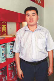 Factory owner Feng Pingjun is one of the beneficiaries of the boom times in Hainan. [China Daily]