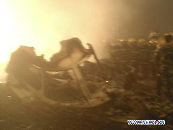 Rescuers and ambulances prepare for medical treatment of the injured near the site of the plane accident in Yichun, northeast China&apos;s Heilongjiang Province, Aug. 24, 2010. A passenger plane with more than 90 people on board overshot the runway at the airport of Yichun City, late Tuesday night, sources said. More than 20 injured have been hospitalized. [Xinhua/Li Guangfu]