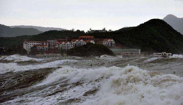 Photo taken on Aug, 24, 2010 shows the big waves lash the beach in Sanya, south China's Hainan Province. High tides and big waves were seen on the sea water near Sanya due to a strong tropical storm named 'Mindulle' Tuesday. 