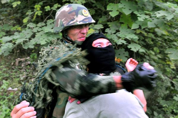 A member of armed police attends an anti-terrorism drill in Chuzhou, east China&apos;s Anhui Province, Aug. 23, 2010. The anti-terrorism maneuver involved some 50 task force members. [Xinhua]