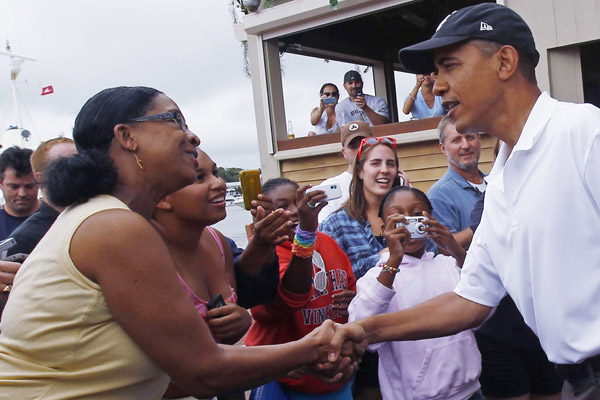 U.S. President Barack Obama greets guests as he arrives for lunch at Nancy&apos;s Restaurant in Martha&apos;s Vineyard in Oak Bluffs, Massachusetts, August 25, 2010. The first family is on a 10-day summer vacation.[Xinhua/Reuters] 