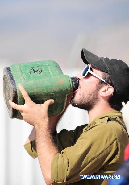 An Israeli soldier drinks in an Israeli military base near the Israel-Lebanon border, on Aug 25, 2010. [Yin Dongxu/Xinhua]