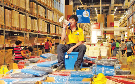 An IKEA employee promotes the company's products at its store in Beijing. [China Daily]