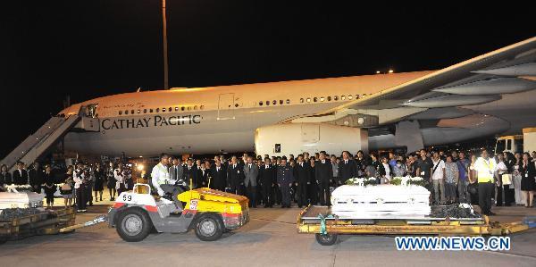 Coffins of victims arrive at the airport in Hong Kong, south China, Aug. 25, 2010. The charter plane carrying tourist group members, victims' relatives and the bodies of the eight victims killed in Monday's hostage crisis in the Philippines arrived at Hong Kong Wednesday. 