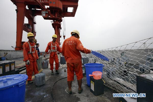 Workers prepare coating materials on the Three Gorges Dam on Aug. 24, 2010. China Three Gorges Corporation began to coat protective painting materials onto the Three Gorges Dam to protect the concrete structure.