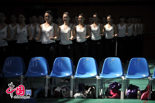 Women selected as Miss Etiquette of the 16th Asian Games, to be held in Guangzhou, receive training at the Shunde campus of Southern Medical University in Guangzhou, South China&apos;s Guangdong province, Aug 20, 2010. [Photo/CFP]