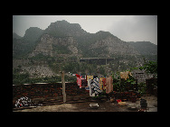 Zhaihuo township in Boai County is situated deep in the mountains in northwest Henan Province. Yangquan, Huangtang and Pandi villages lie in the northeastern part of the township. The surrounding mountains provide the local villagers with source of life. The highway in the distance is an expressway linking Henan and neighboring Shanxi Province and runs through the three villages. [China.org.cn]