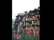 Photo exhibit the beauty of the ancient town of Phoenix, which is located in the Phoenix County in the Tujia and Miao ethnic minority Autonomous Prefecture in Hunan province. Built adjacent to the Tuo River, it is a national historical and cultural town with a long history and many places of interest. The town has been named 'the most beautiful whistle stop' in china. [Photo by Yang Nan]