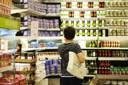 A customer shops at an area specially dedicated to imported goods at a supermarket in Beijing in this June 19 photo. [Global Times]