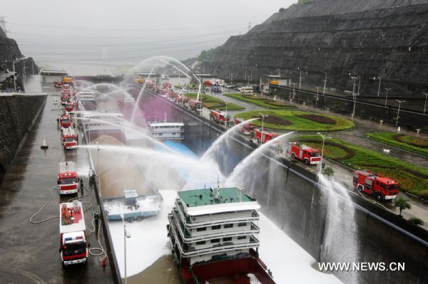 Fire engines spay water to vessels locked in the Three Gorges Dam during a fire drill in Yichang, central China's Hubei Province, Aug. 26, 2010. Some 200 staff members from local public service departments joined in the drill Thursday. [Xinhua photo]