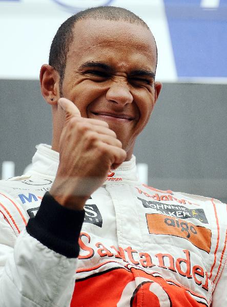 McLaren Mercedes driver Lewis Hamilton of Britain celebrates on the podium after winning the Belgium Formula One Grand Prix at the Spa-Francorchamps circuit, Belgium, Aug. 29, 2010.(Xinhua/AFP Photo)