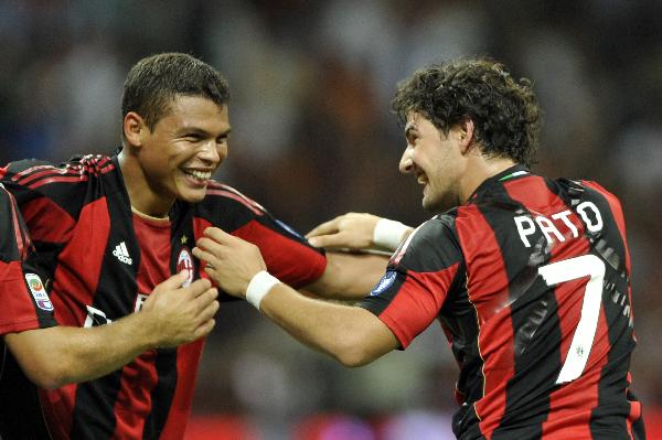 AC Milan defender Thiago Silva, left, of Brazil, celebrates with his teammate Brazilian forward Pato after scoring during the Serie A soccer match between AC Milan and Lecce at the San Siro stadium in Milan, Italy, Sunday, Aug 29, 2010. AC Milan won 4-0.