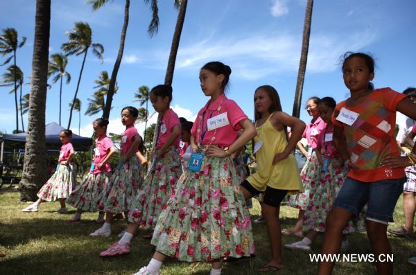 Hawaiian girls and Chinese girls of Shanghai Soong Ching Ling Foundation Children's Palace Art Troupe practise hula dance in Honolulu, Hawaii, the United States, Aug. 28, 2010. Forty-five students of the art troupe arrived in the resort on Aug. 24 to spend five days with their counterpart in Hawaii and to promote the Shanghai 2010 World Expo. 