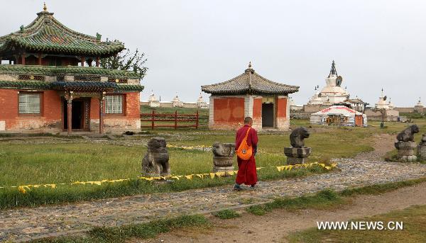 The picture taken on Aug. 13, 2010 shows a Lama walks in front of the ancient buildings at Karakorum, the ruined ancient capital of Mongolia. Karakorum locates some 360 kilometers west of Ulan Bator, capital of today's Mongolia. The ruined capital was built in the early 13th century by Ogadai, son of Genghis Khan, but was later destroyed by war. [Xinhua/A Sigang]