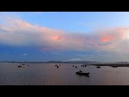 Crimson clouds at sunset are seen over a harbour of Zhoushan City, east China's Zhejiang Province, Aug. 31, 2010. [Xinhua]