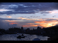 Crimson clouds at sunset are seen in a harbour of Zhoushan City, east China's Zhejiang Province, Aug. 31, 2010.  [Xinhua]