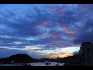 Crimson clouds at sunset are seen in a harbour of Zhoushan City, east China's Zhejiang Province, Aug. 31, 2010.  [Xinhua] 