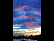 Crimson clouds at sunset are seen in a harbour of Zhoushan City, east China's Zhejiang Province, Aug. 31, 2010.  [Xinhua] 