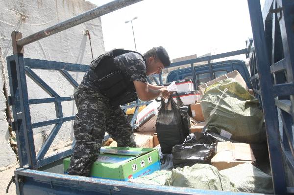 An Iraqi soldier searches a truck at a checkpoint in Baghdad on August 31,2010.[Xinhua/AFP]