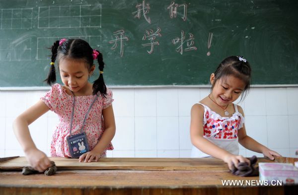 Two girl students clean the platform at a school in Xinjian County, east China&apos;s Jiangxi Province, Sept. 1, 2010. Most primary schools and middle schools in China started the new semester Wednesday. [Xinhua] 