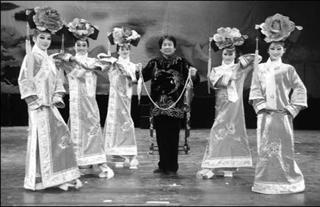 Tian Xueming, the troupe's founder and head, performs a magic show.