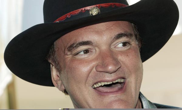 U.S. director and producer Quentin Tarantino smiles as he poses for pictures on arrival at the Excelsior Palace in Venice August 31, 2010. Tarantino will be the president of International Jury at the 67th Venice Film Festival.