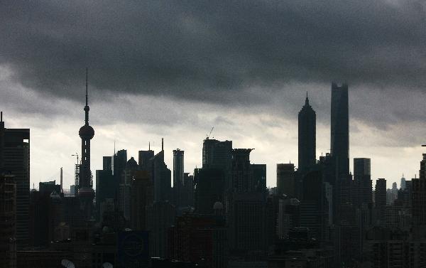 Dark cloud is seen over downtown Shanghai, east China, Aug. 31, 2010. Heavy rains and thunderstorms are predicted to hit Shanghai as this year's six, seventh and eighth tropical storms are active at sea in east China. 